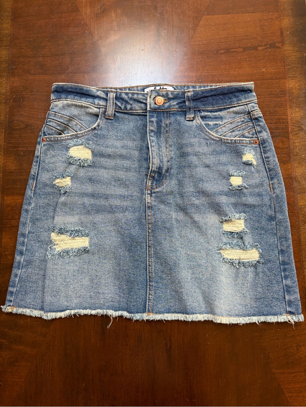 High-Rise Distressed Denim Mini Skirt in Light Blue